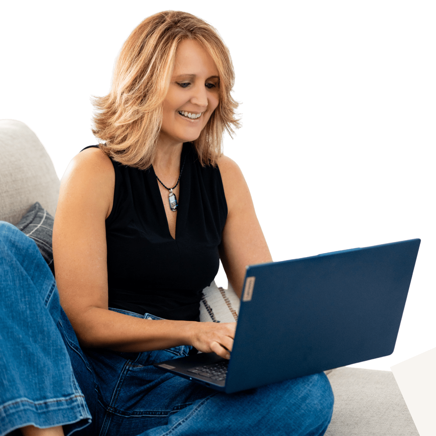 Woman smiling while using a laptop.