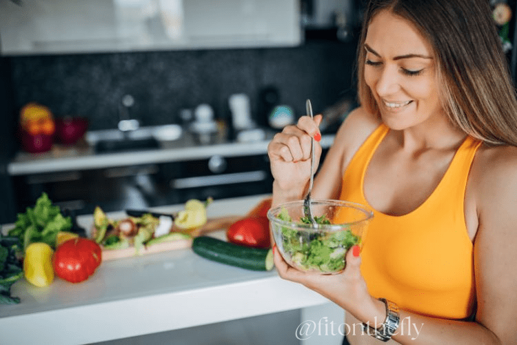 Healthy Woman Enjoying Fresh Green Salad in Kitchen