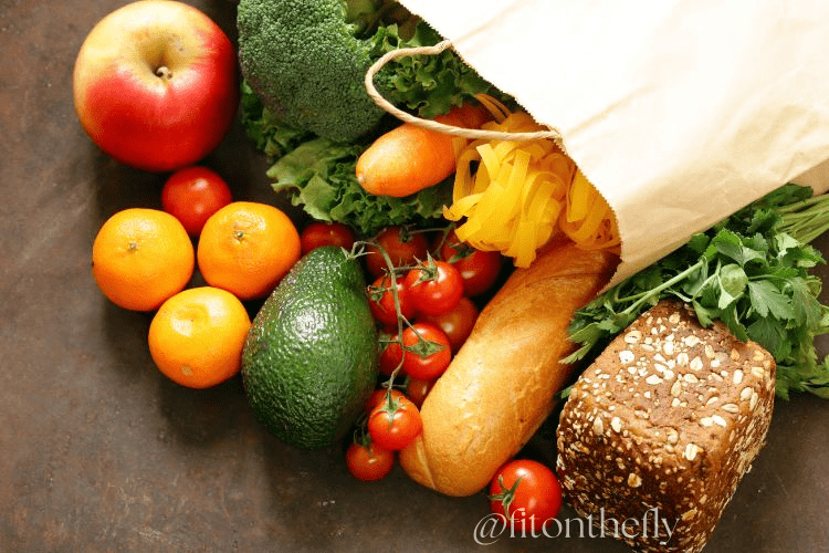 Fresh Groceries Including Fruits, Vegetables, Bread, and Pasta in Paper Bag.