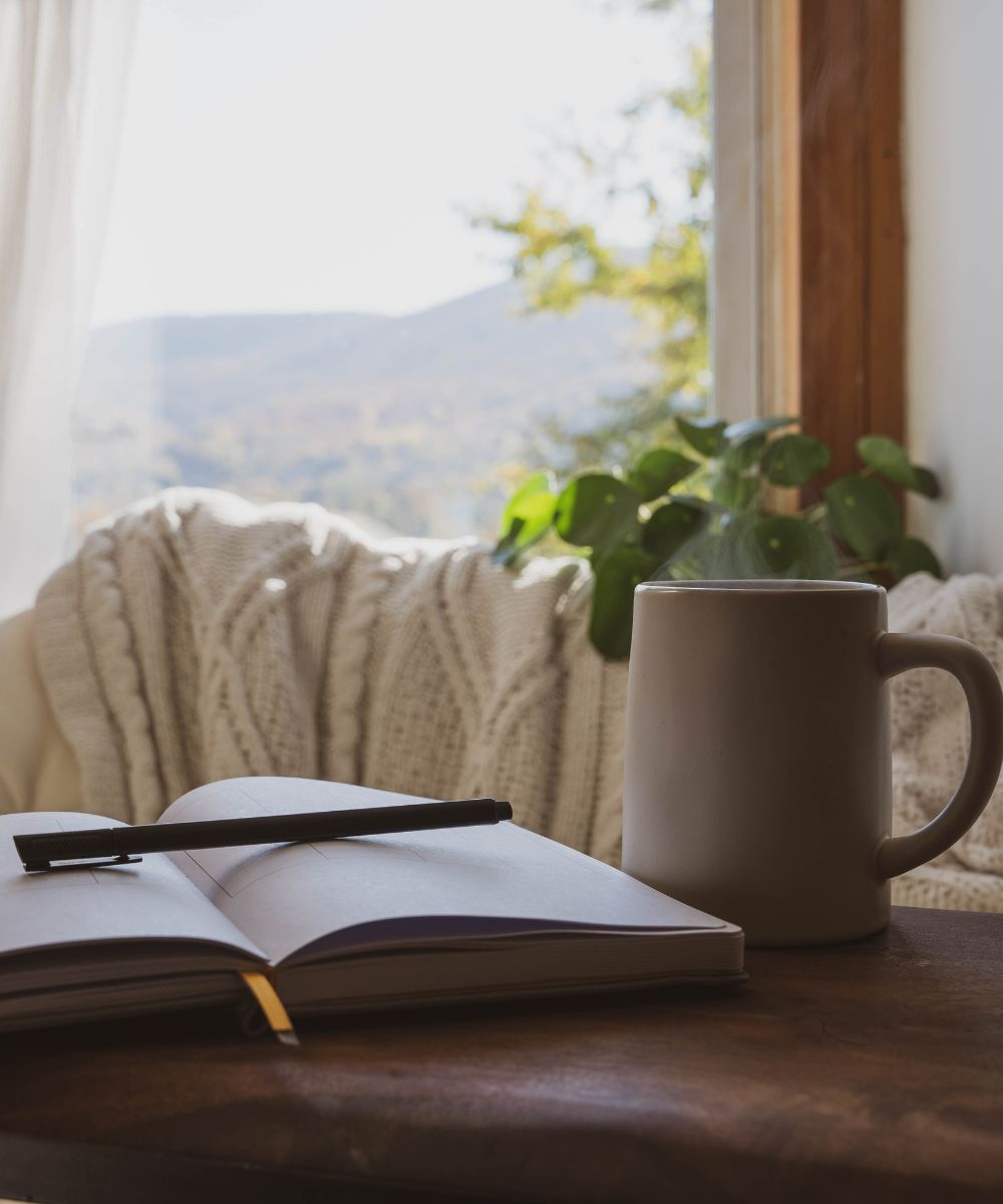 Cozy nook with journal and coffee mug.