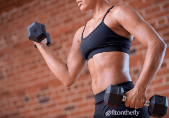 Woman doing arm workout with dumbbells at home